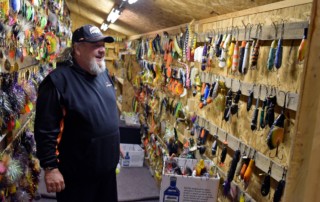 Fishing guide and muskie expert Tony Grant enters his "man cave" to select lures for the day's outing.