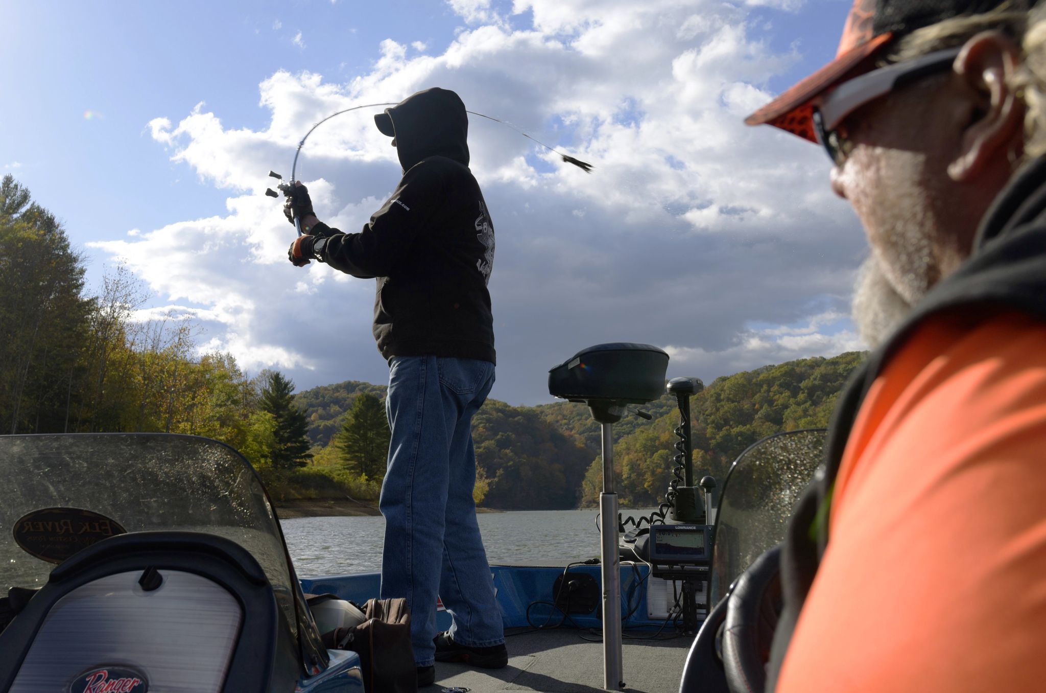 Louie Friedman casts toward the shoreline of Cave Run Lake as tour guide Tony Grant looks on.