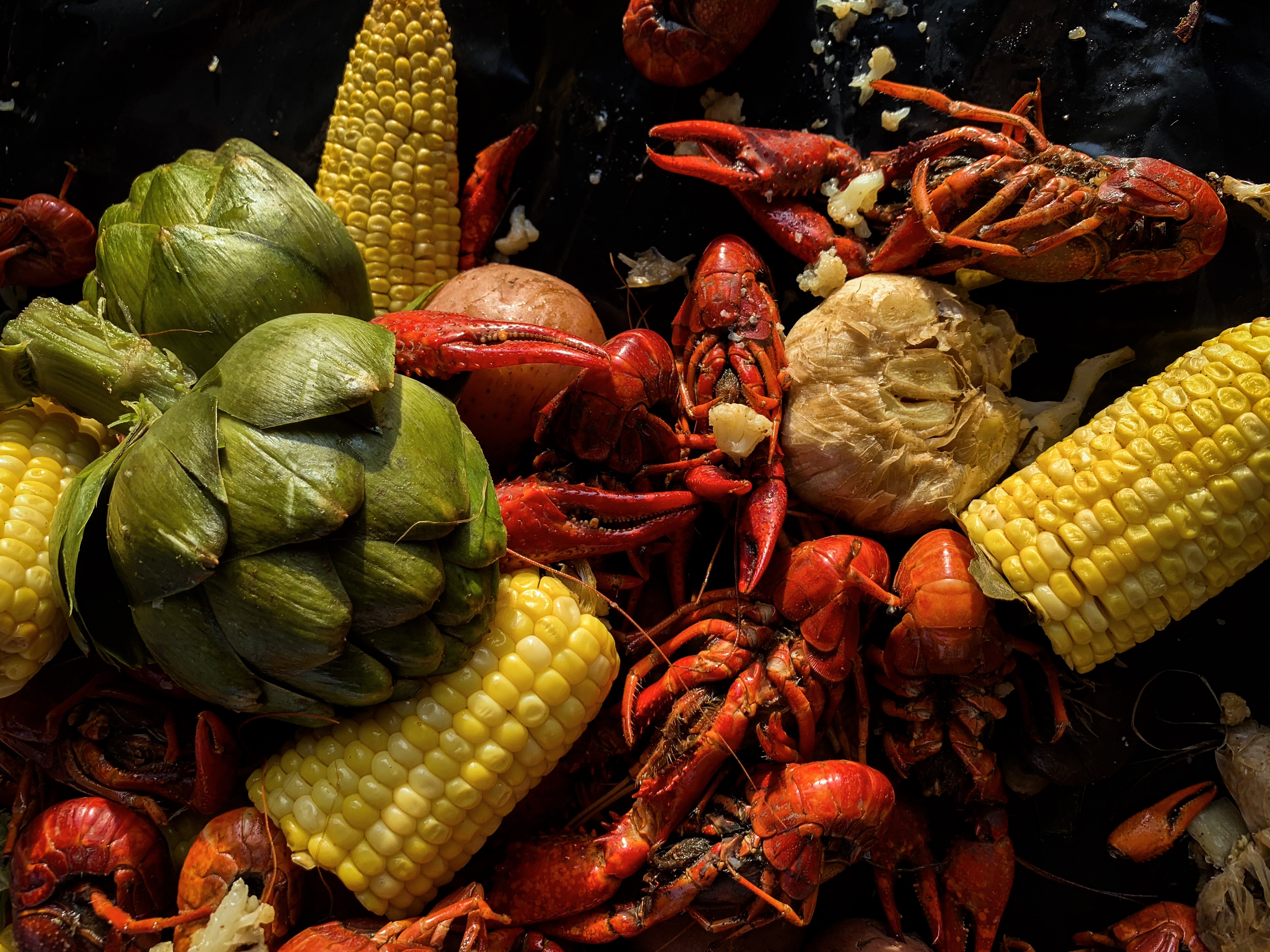 Crawfish boil with artichokes, corn and cauliflower