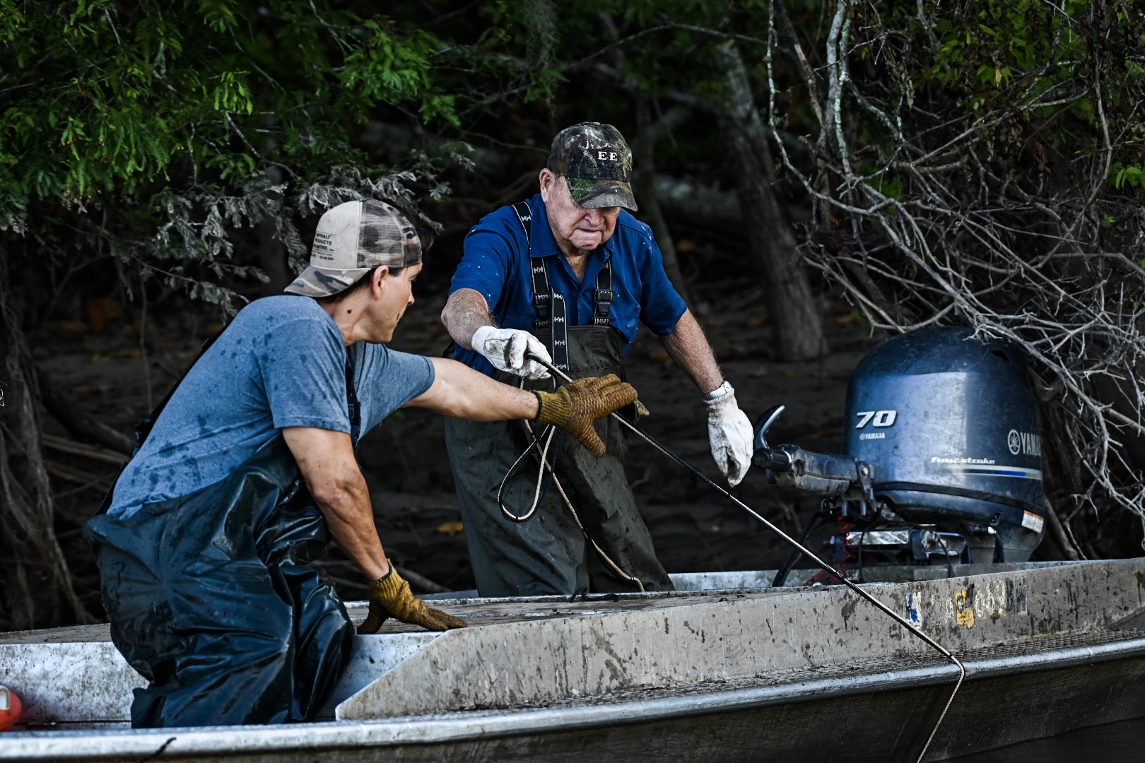 Wilven and Phillip drag the river bottom in search of a hoop net