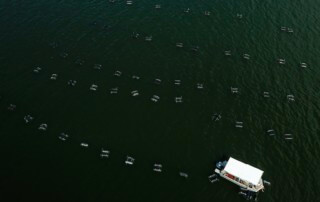 Floating oyster beds and boat at Grand Isle Sea Farms