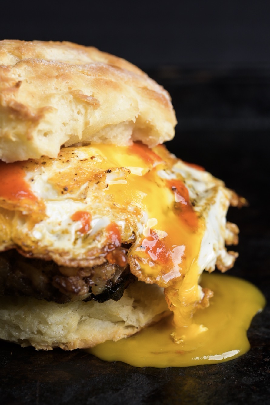 Hot boudin and a fried egg on a buttermilk biscuit