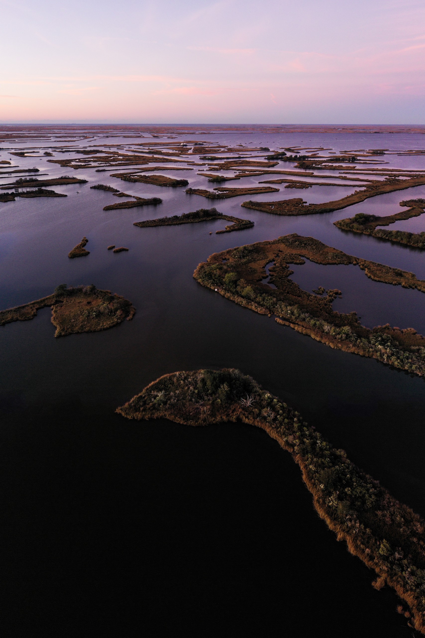 An aerial view of canal lines and marsh grass in Golden Meadow, Louisiana
