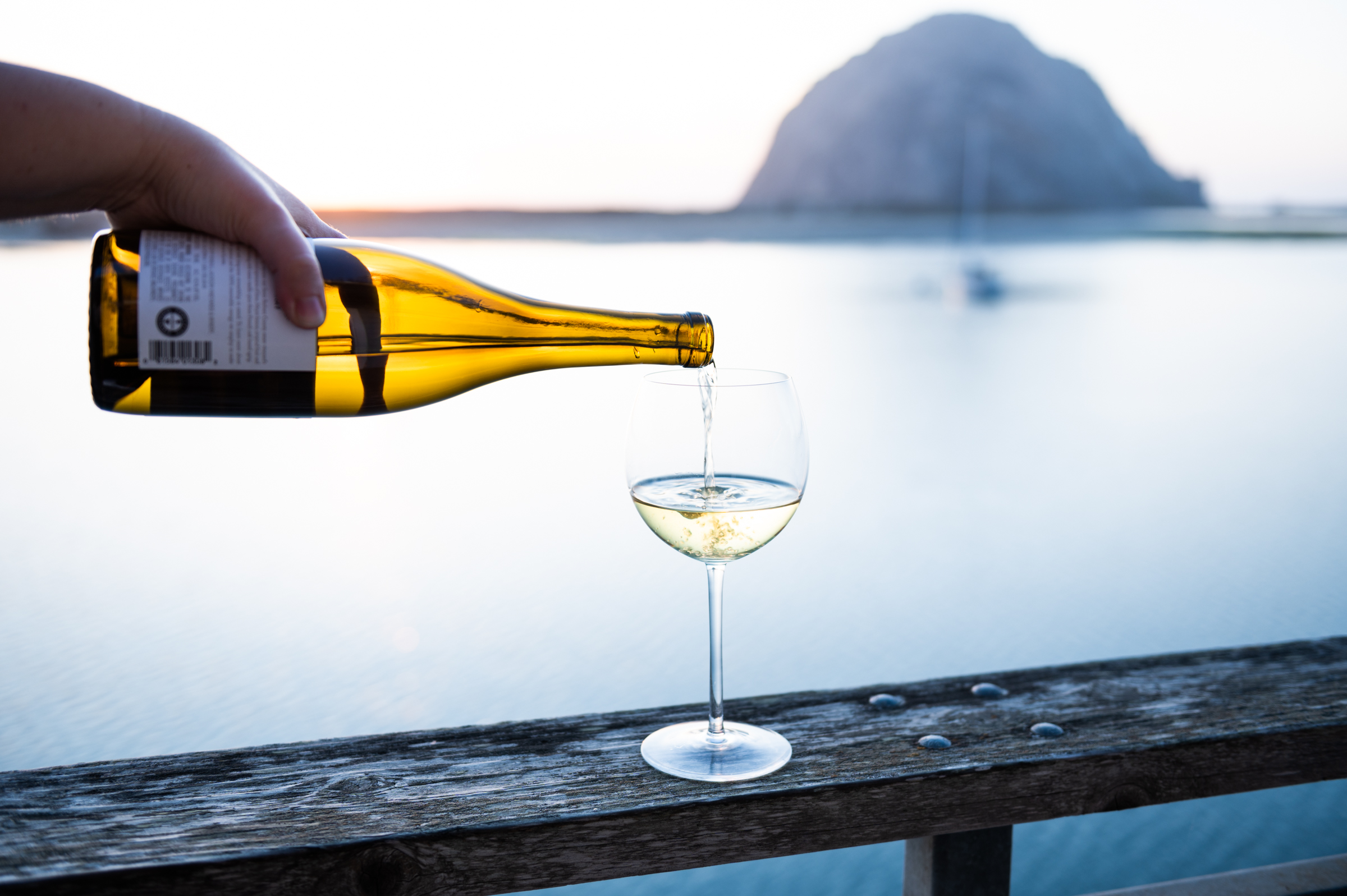California chardonnay being poured in front of Morro Rock