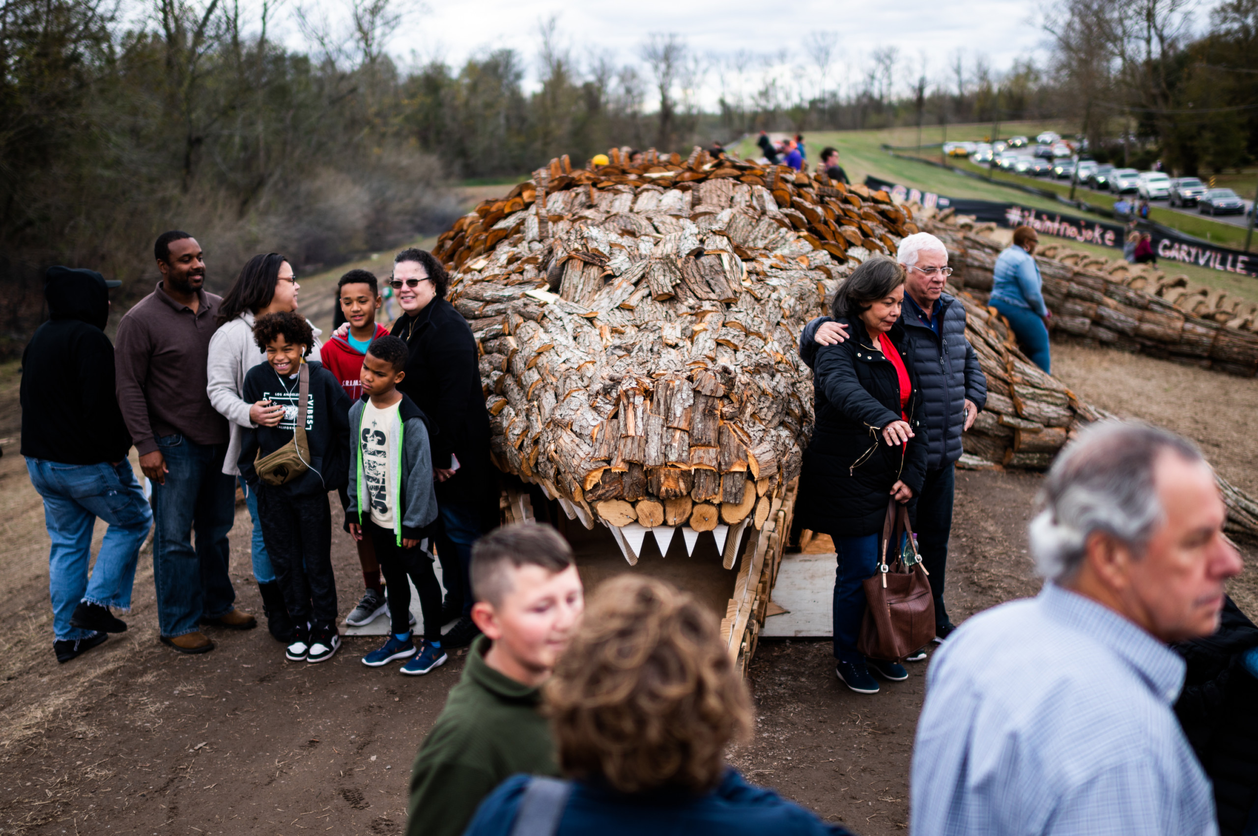 Families gathered for photos in front a 78-foot wooden sculpture of an alligator, part of Garyville's annual Christmas Eve bonfires