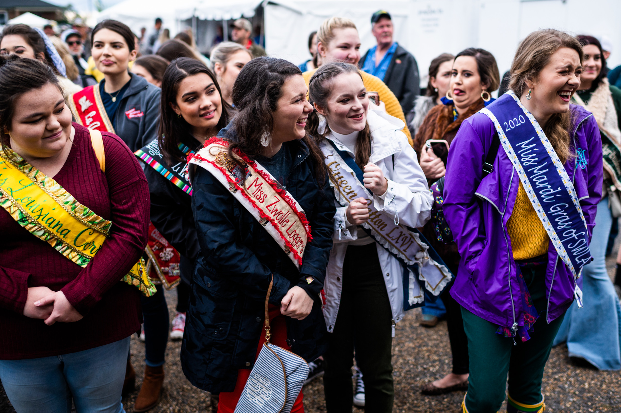 A crowd of festival queens reacts to the muskrat skinning competition