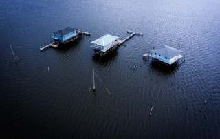 Three houses surrounded by water in Lake Hermitage