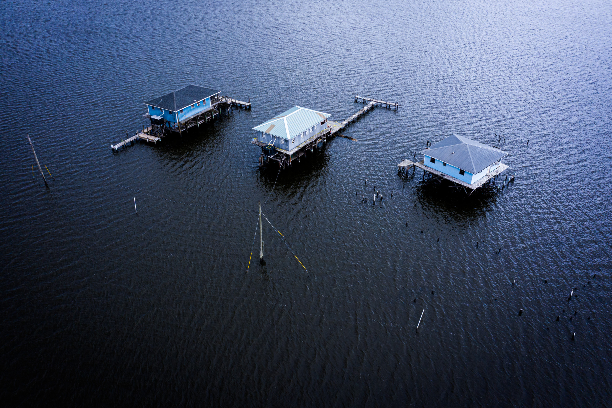 Three houses surrounded by water in Lake Hermitage