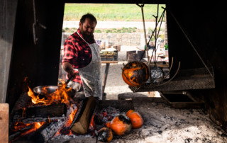Cooking in the open pit of Ironbound Farms's "Mother Fire"