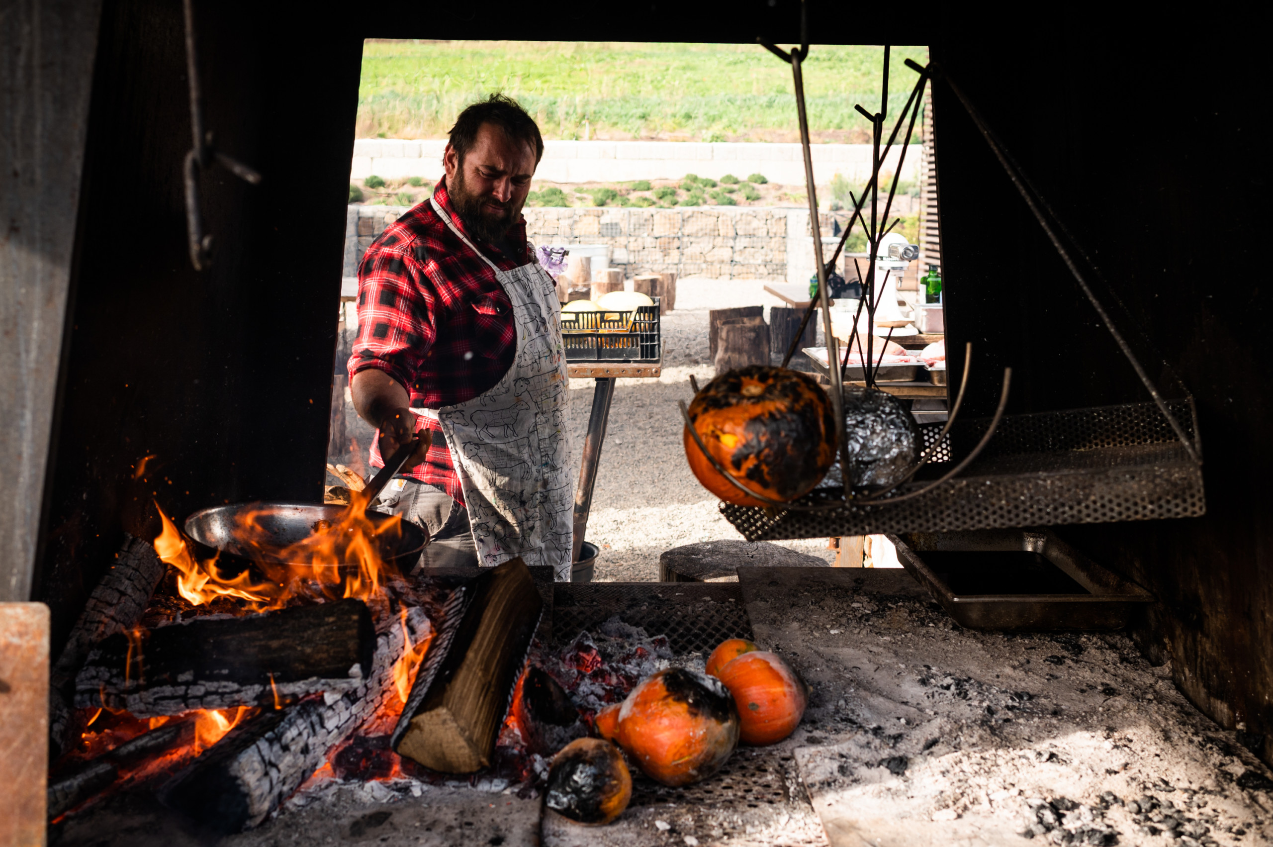Cooking in the open pit of Ironbound Farms's "Mother Fire"