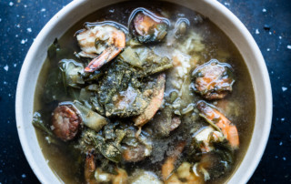 Gumbo z'herbes with a mix of greens, smoked duck sausage, and Louisiana shrimp