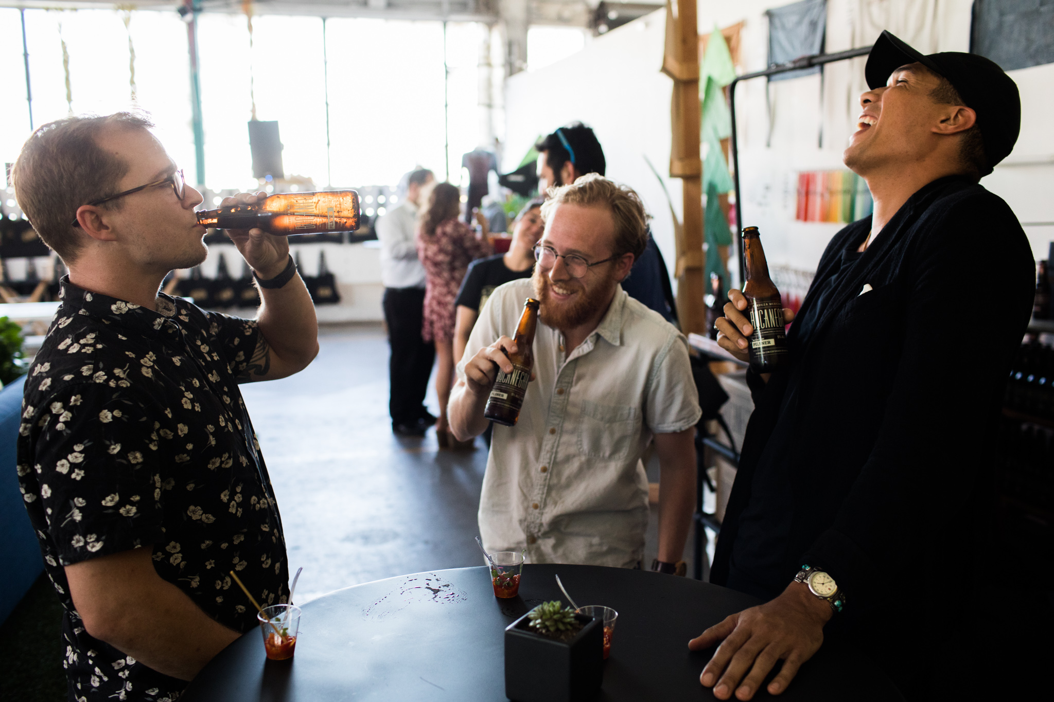 Guests laugh while enjoying Bocanegra beers