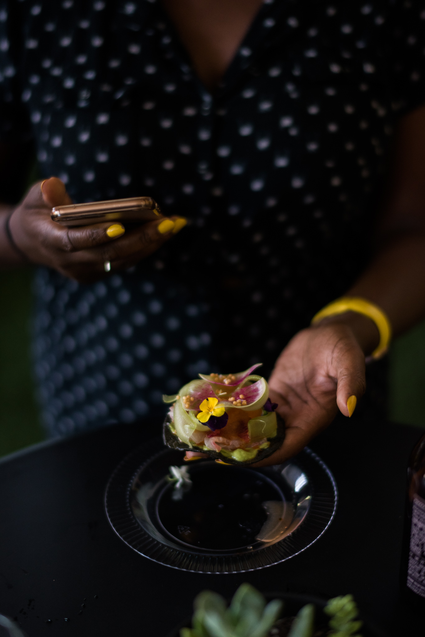 A guest takes a photo of her taco