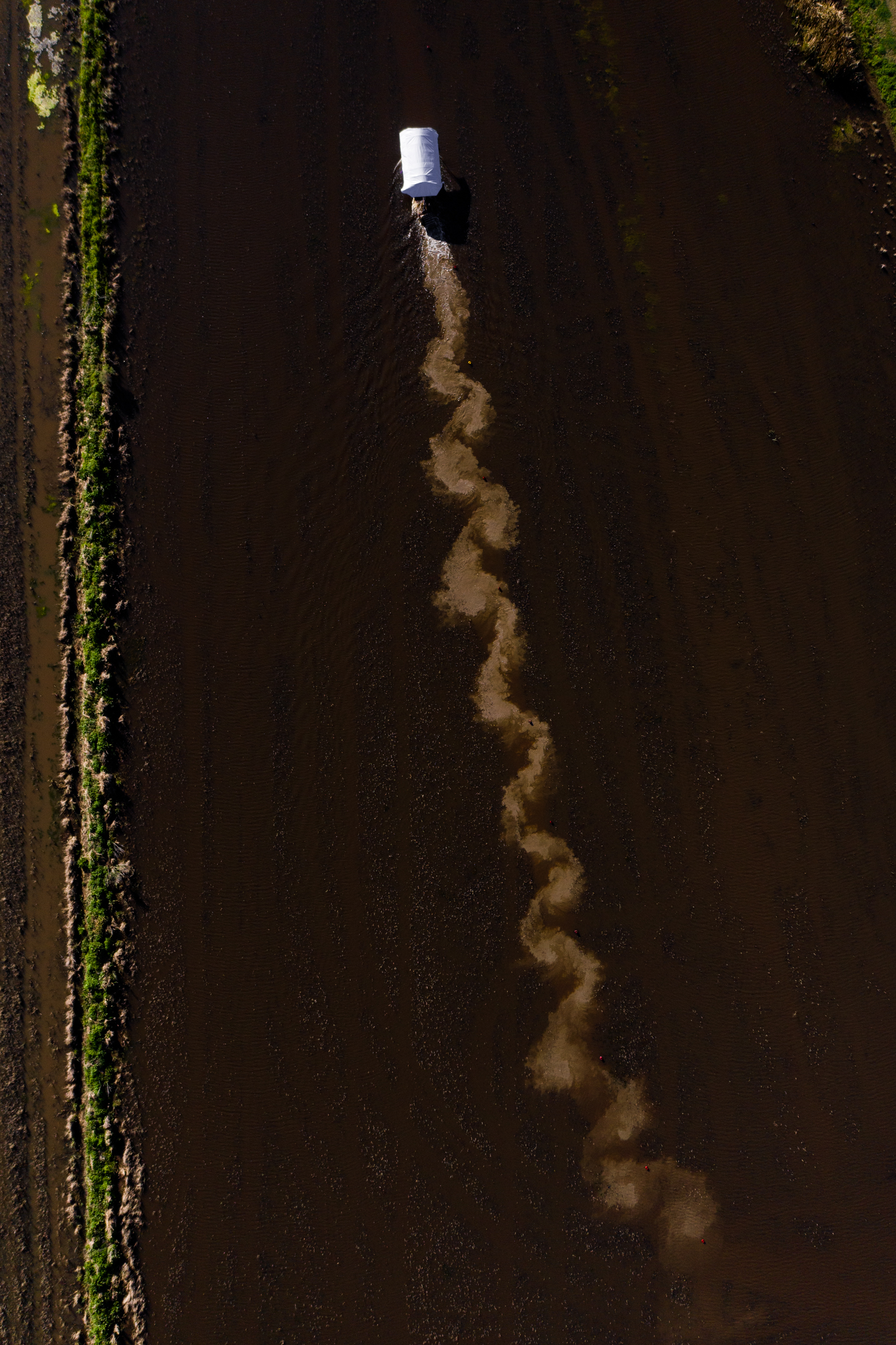 Aerial view of the mud trail behind a crawfish boat