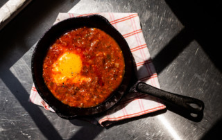 Fried egg in tomato sauce with olive oil