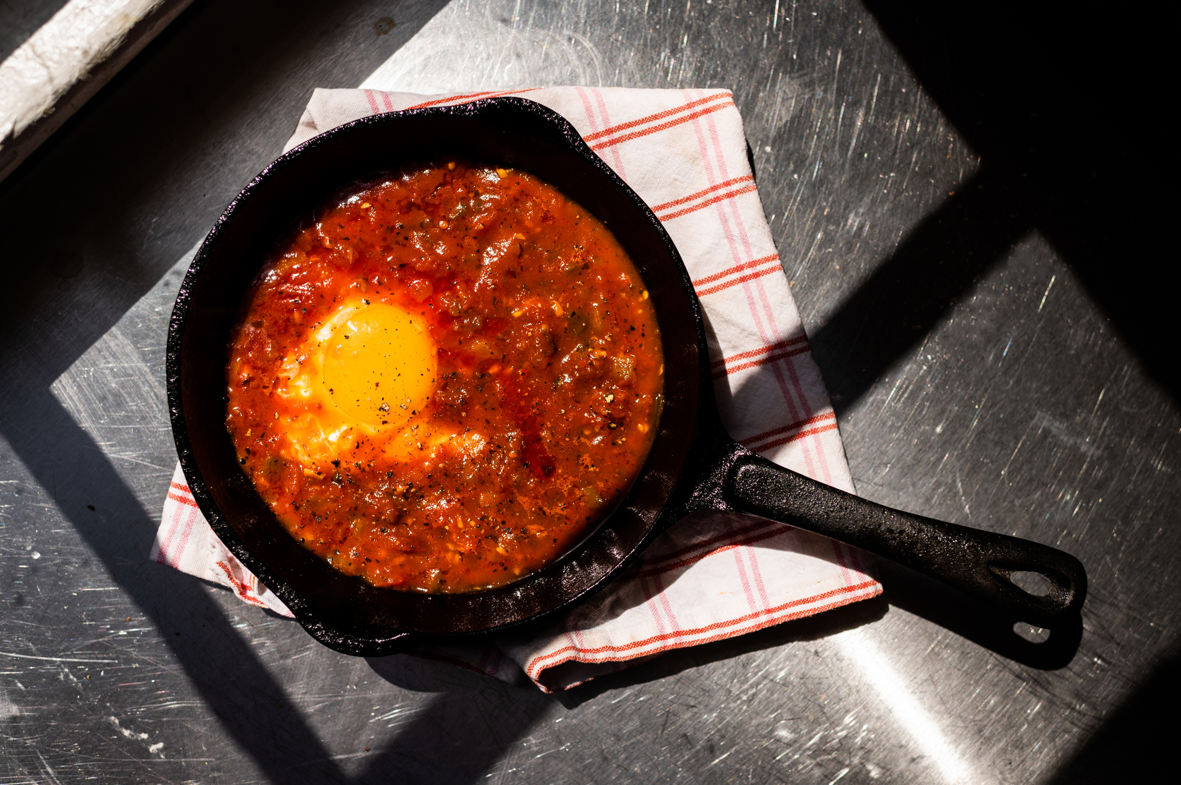 Fried egg in tomato sauce with olive oil