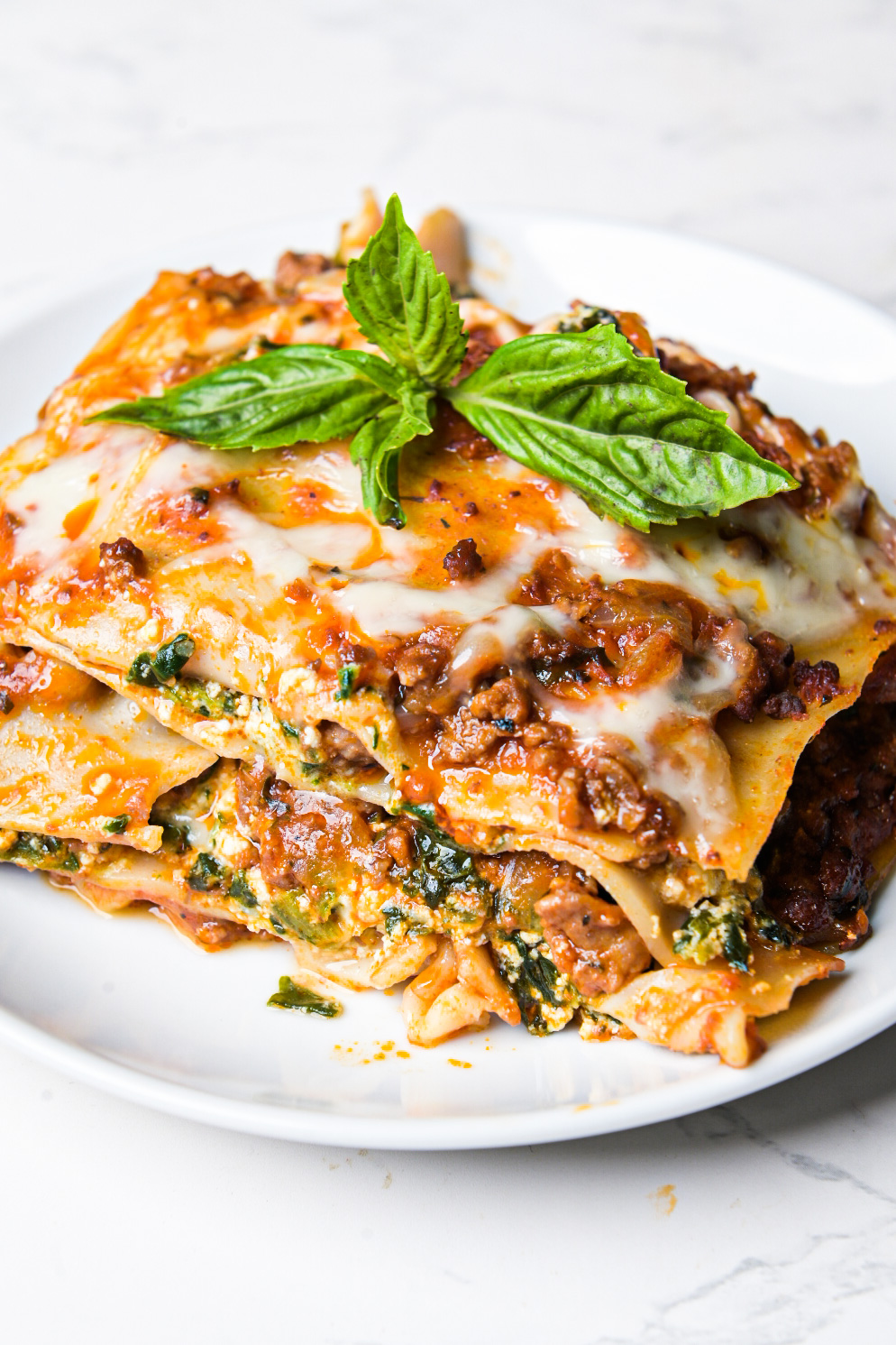 A slice of gluten-free lasagna with meat sauce