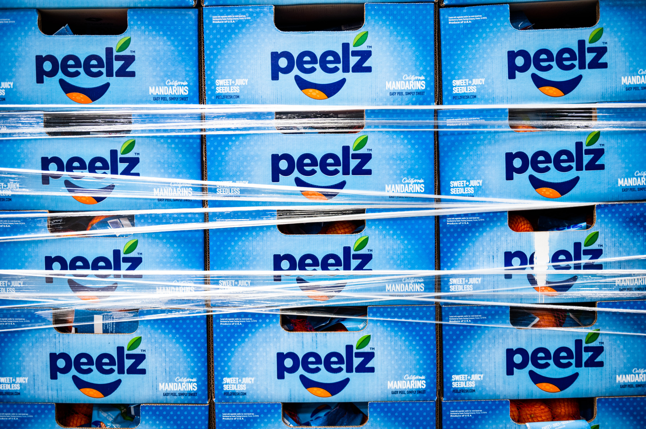 Cases of Peelz mandarins washed, bagged, boxed, stacked, wrapped and ready for storage