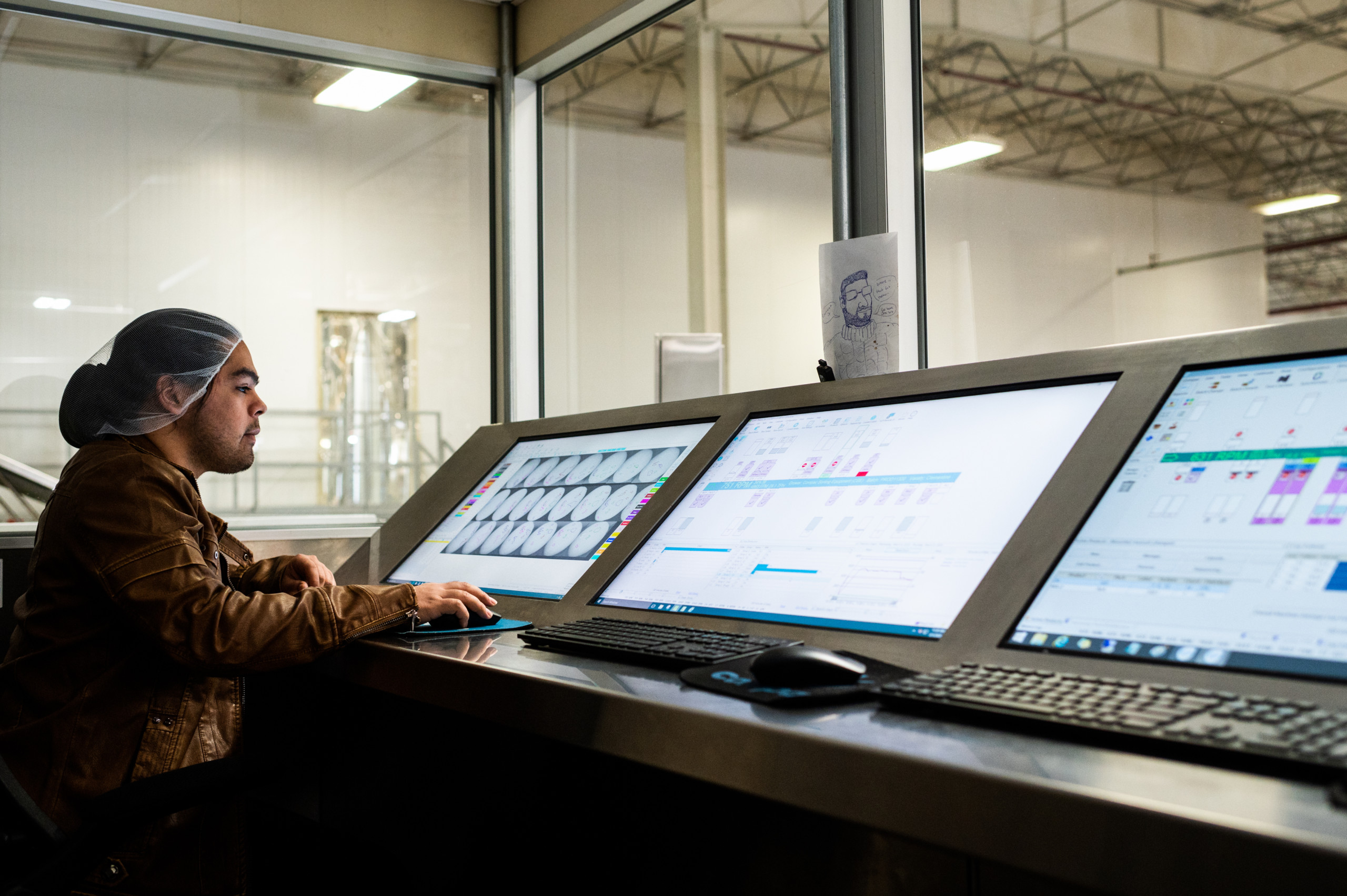 A technician at Fowler Packing inspects scans of fruit from the packing line