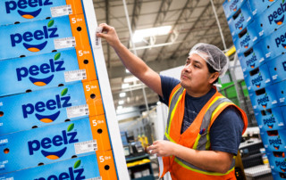 An employee prepares pallets for storage