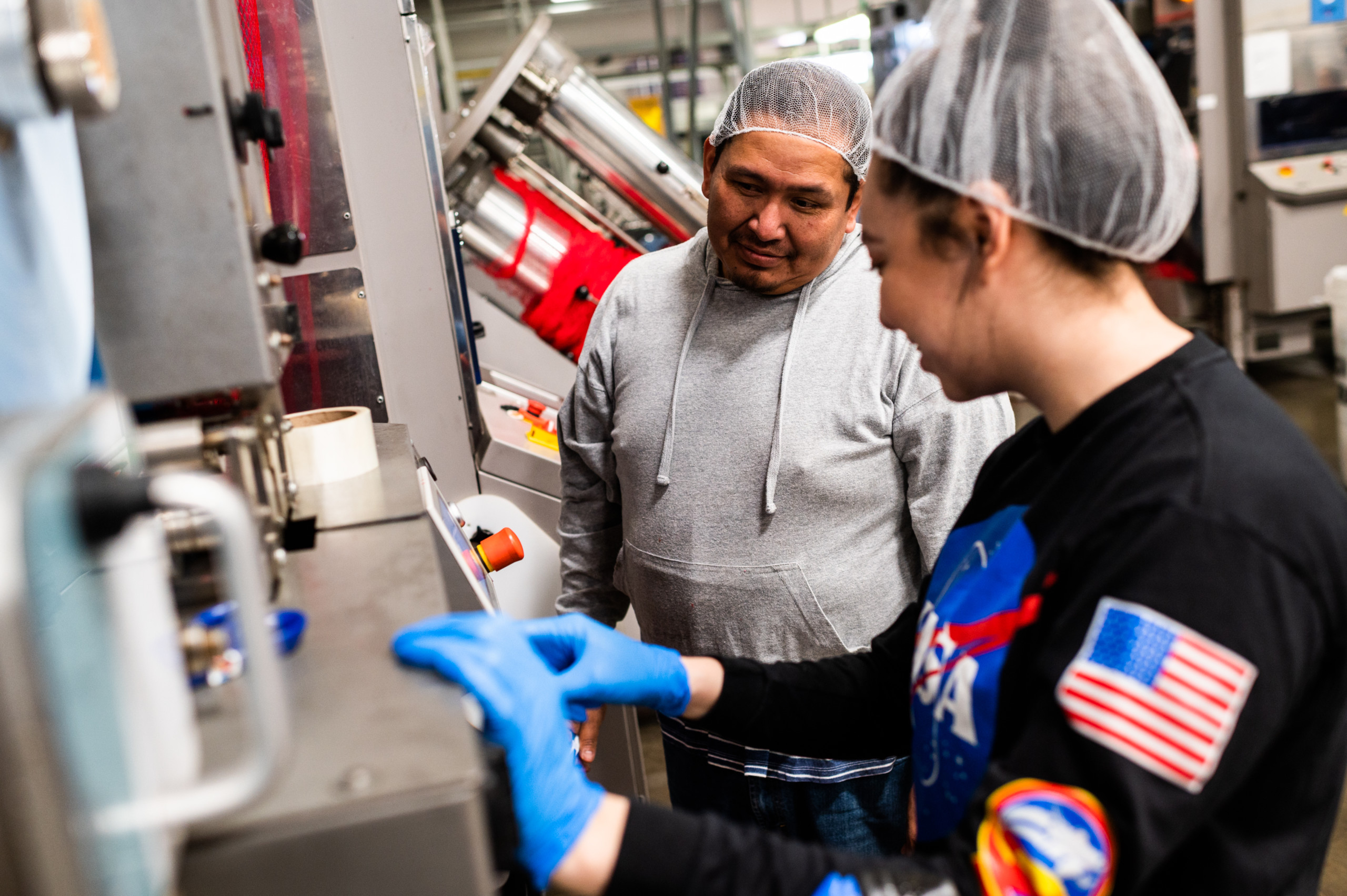 Fowler Packing employees inspect packing machinery