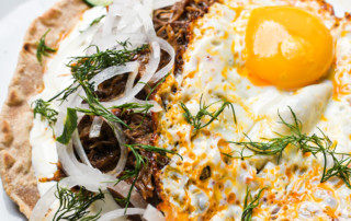 Braised lamb neck roti with a chili oil fried egg