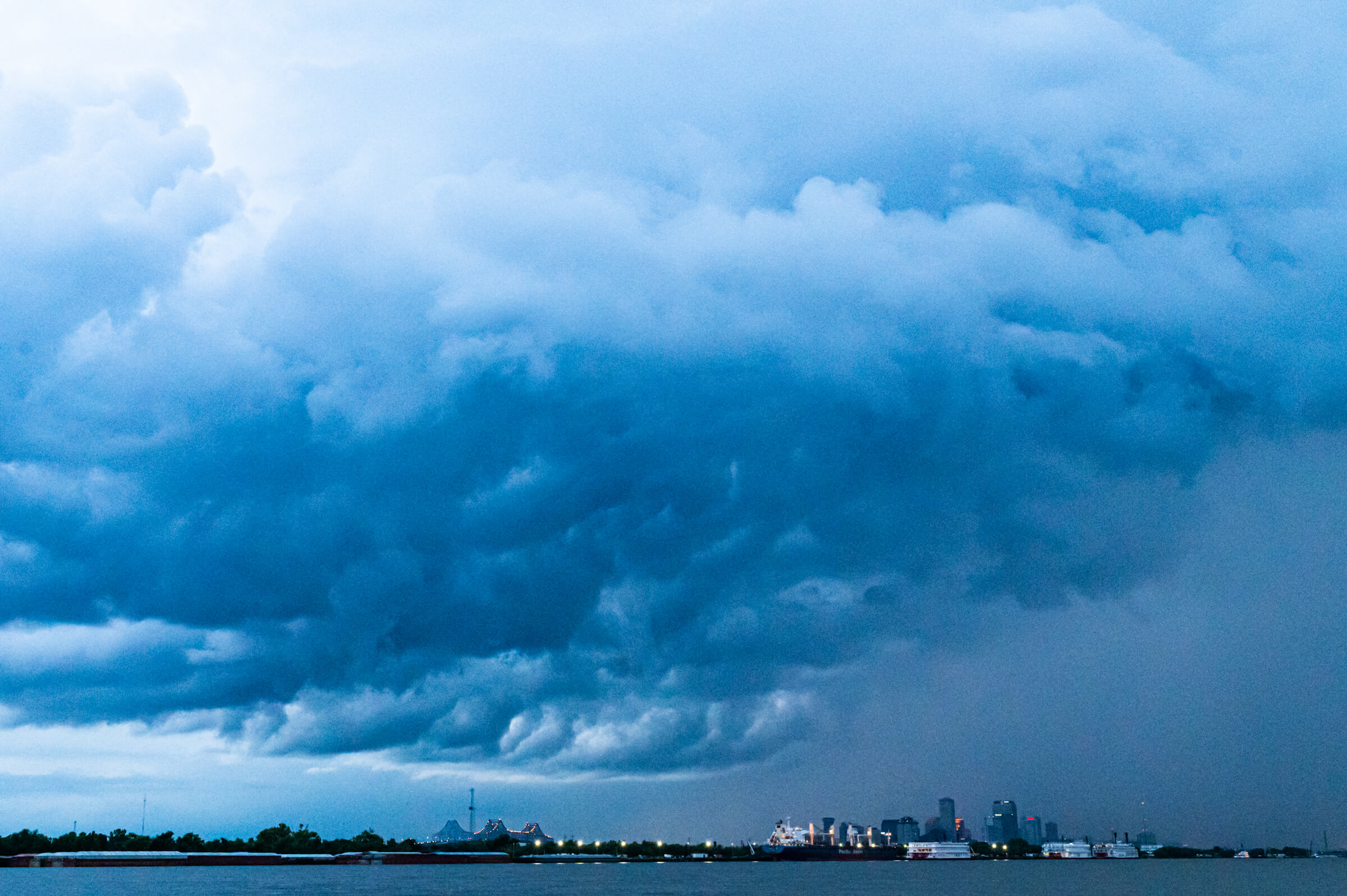 A storm passes over New Orleans, photographed from the river in Arabi