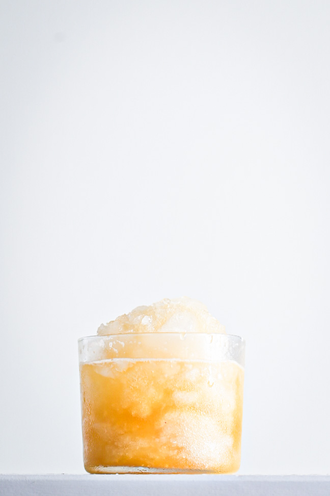 Homemade snoball with shaved ice and syrup made from fresh mandarin and lemon juice