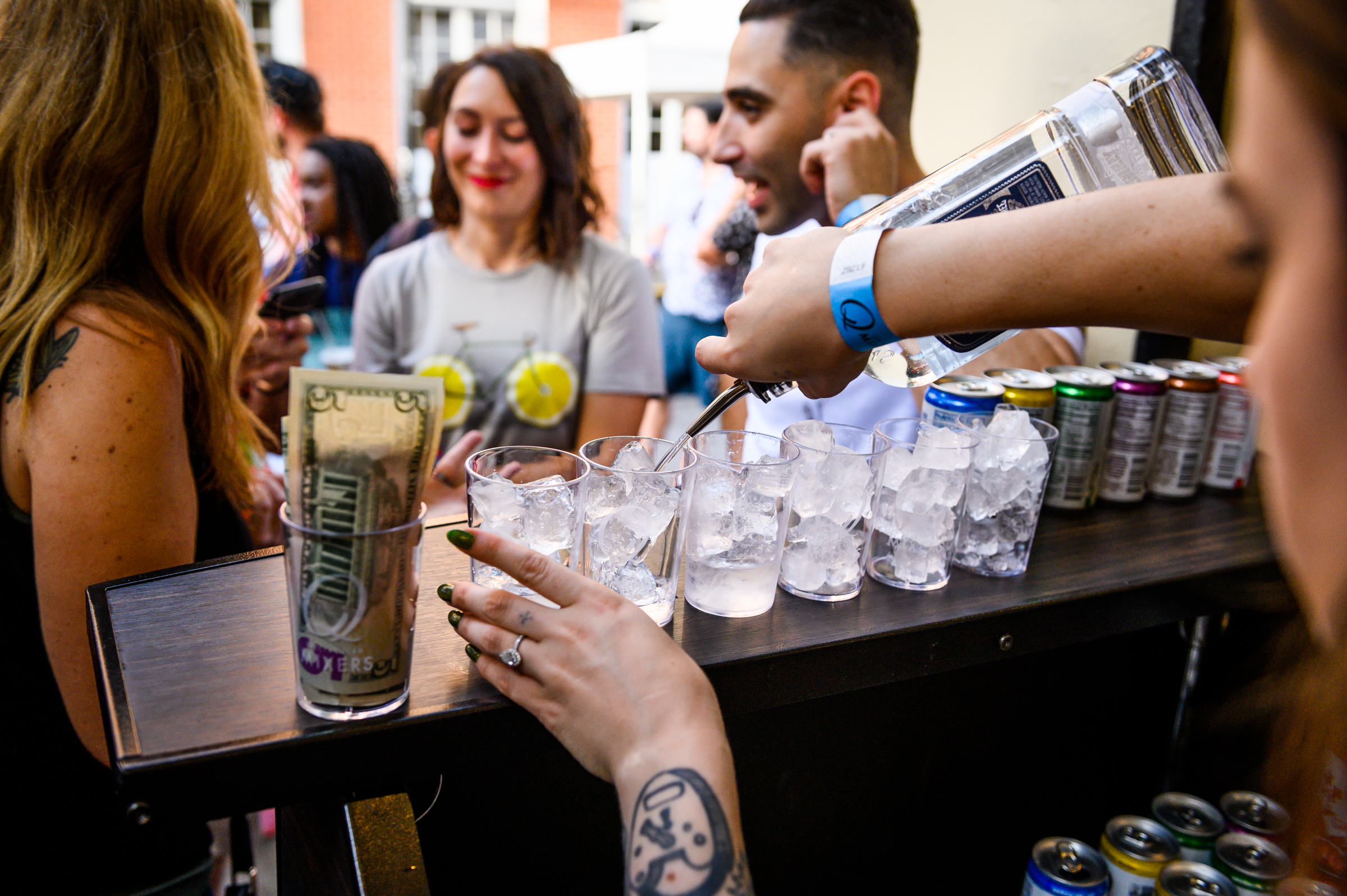 A bartender for Q Mixers pours drinks at a block party in the French Quarter