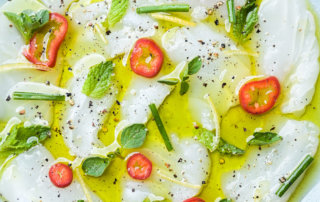 Halibut crudo with fresh herbs, Fresno chili, and ENZO Olive Oil's Eureka Lemon Crush