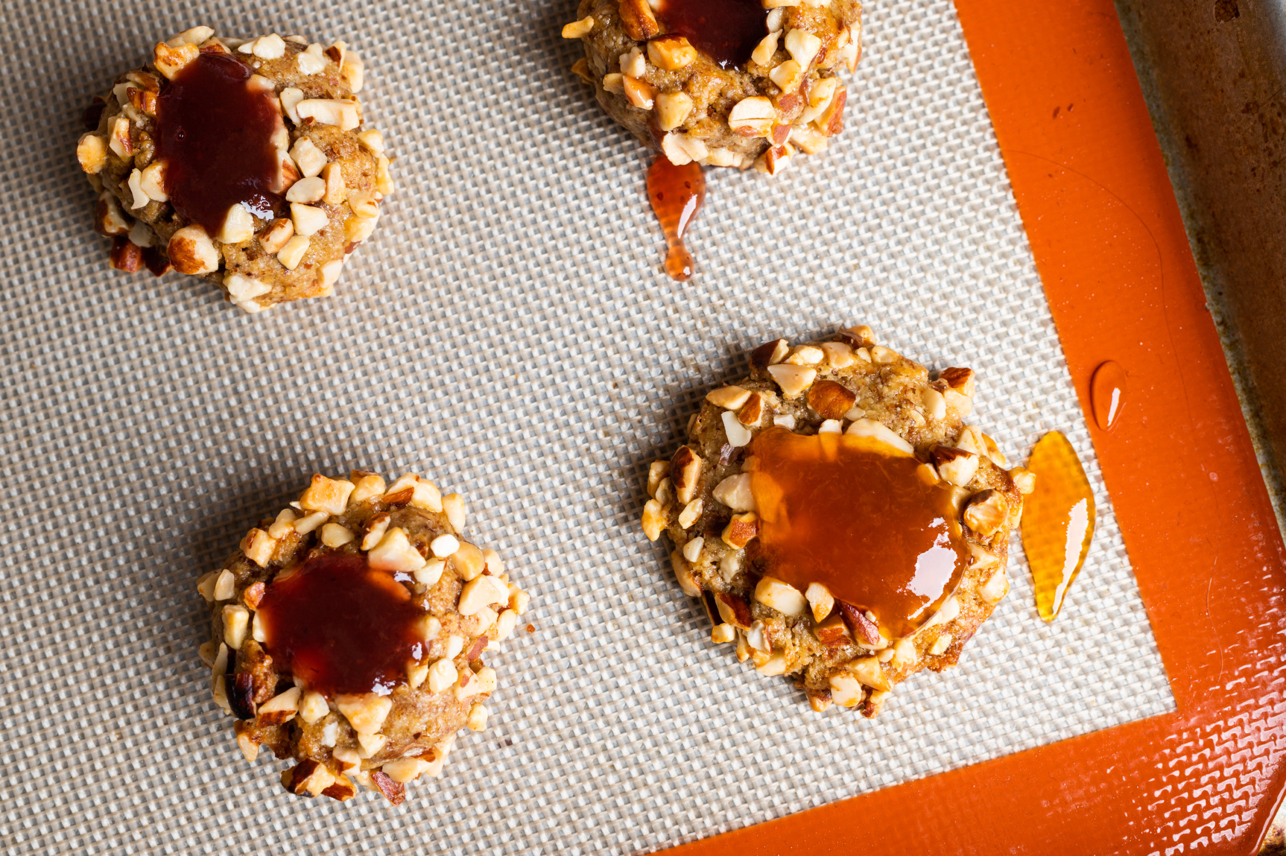 Details of almond thumbprint cookies filled with fruit jam