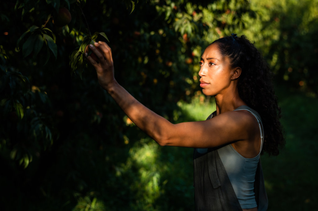 Amber Balakian of Balakian Farms picks a peach from her family's orchard