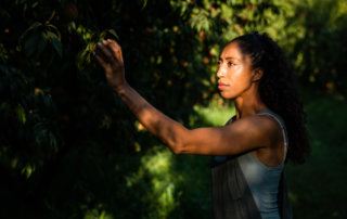 Amber Balakian of Balakian Farms picks a peach from her family's orchard