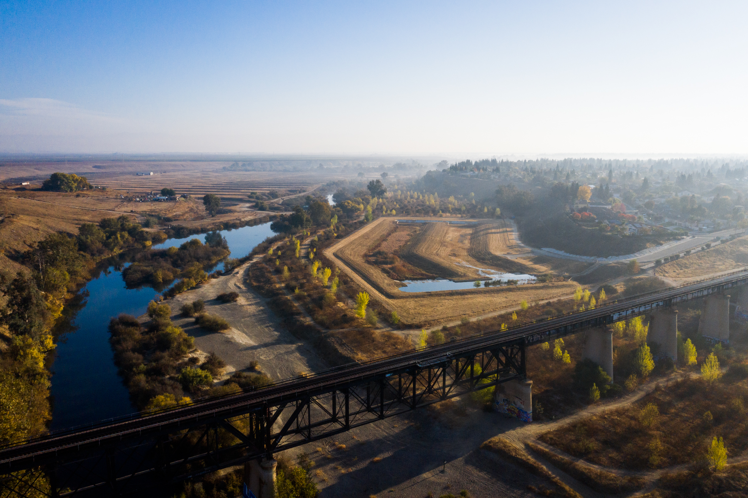A view looking east along the river the divides Fresno and Madera, California