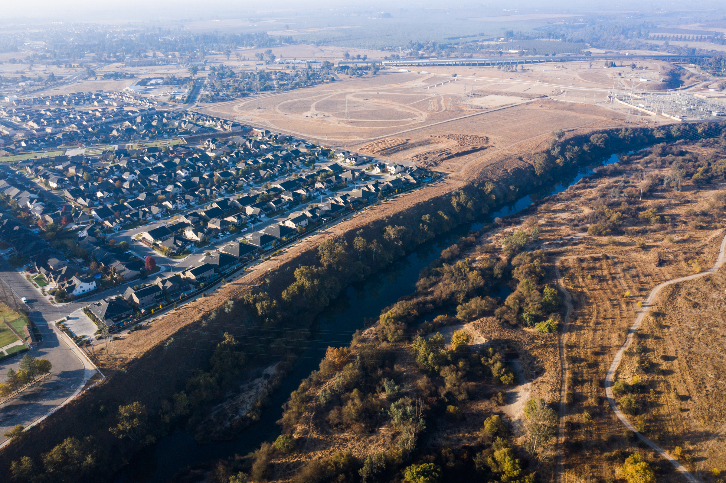 Fresno housing developments crowd the southern edge of the San Joaquin River