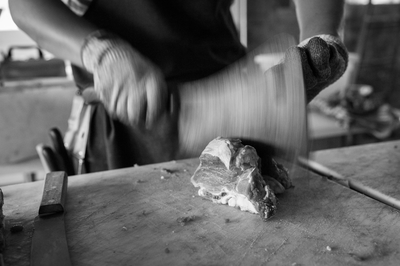 The antique cleaver in action on a cut of lamb