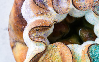 Details of cardamom meringue and hand-dyed sugars on a Bayou Saint Cake king cake