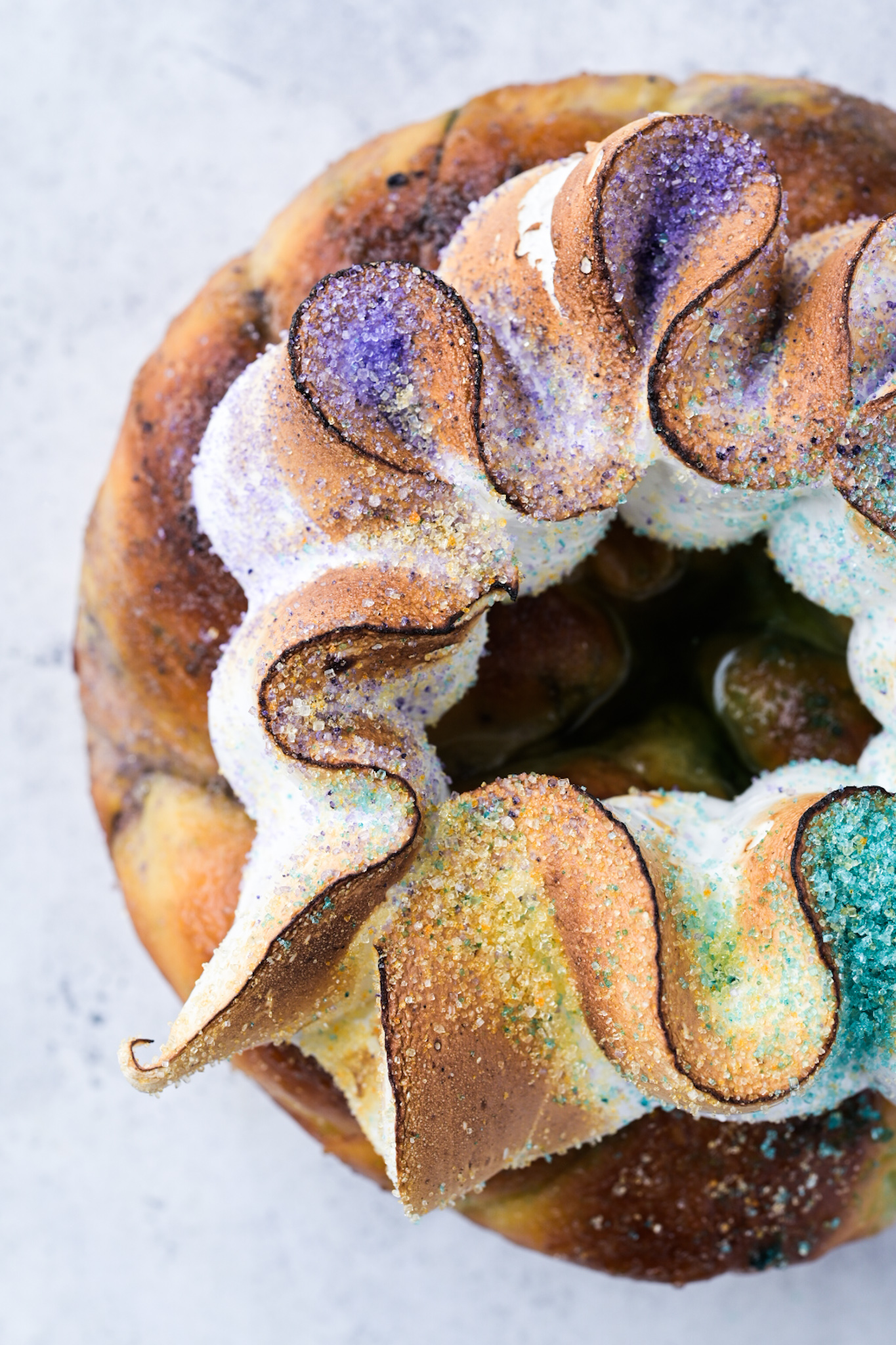 Details of cardamom meringue and hand-dyed sugars on a Bayou Saint Cake king cake