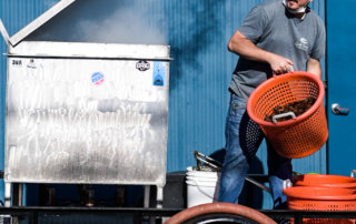 Evan Troxell of Gulf Coast Crawfish adds crawfish to a boil