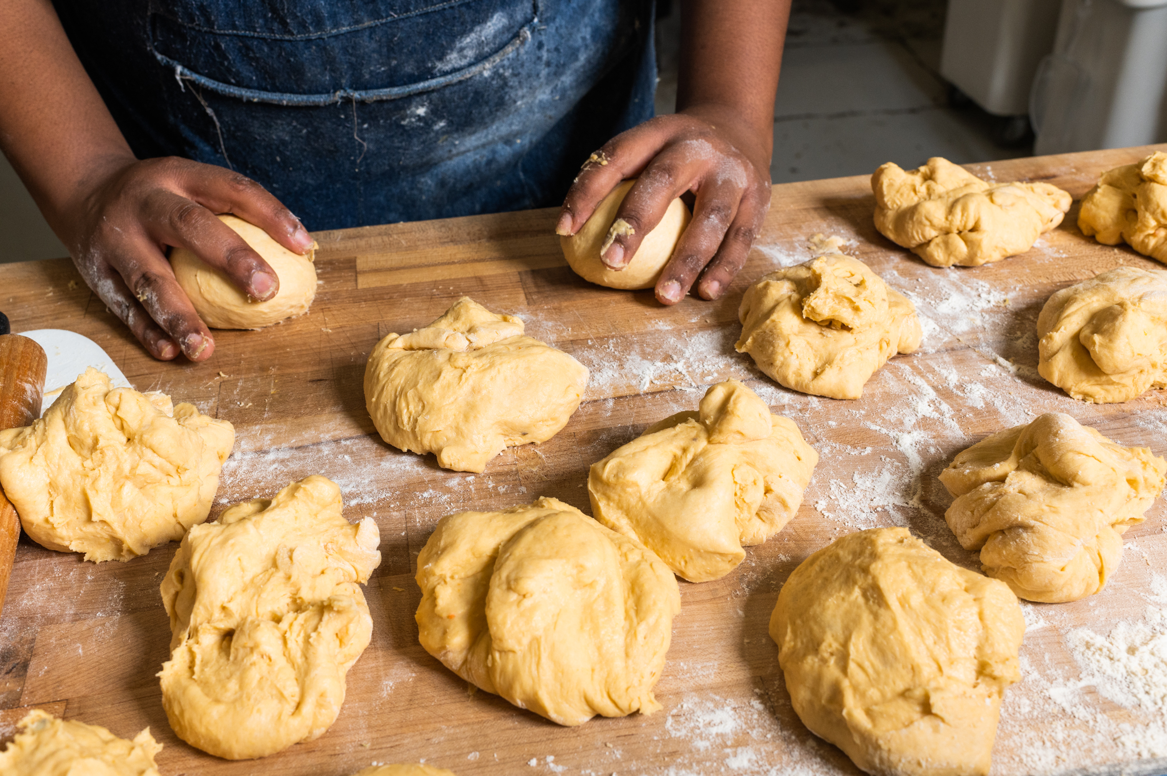 Once portioned, the dough is rolled into smooth balls