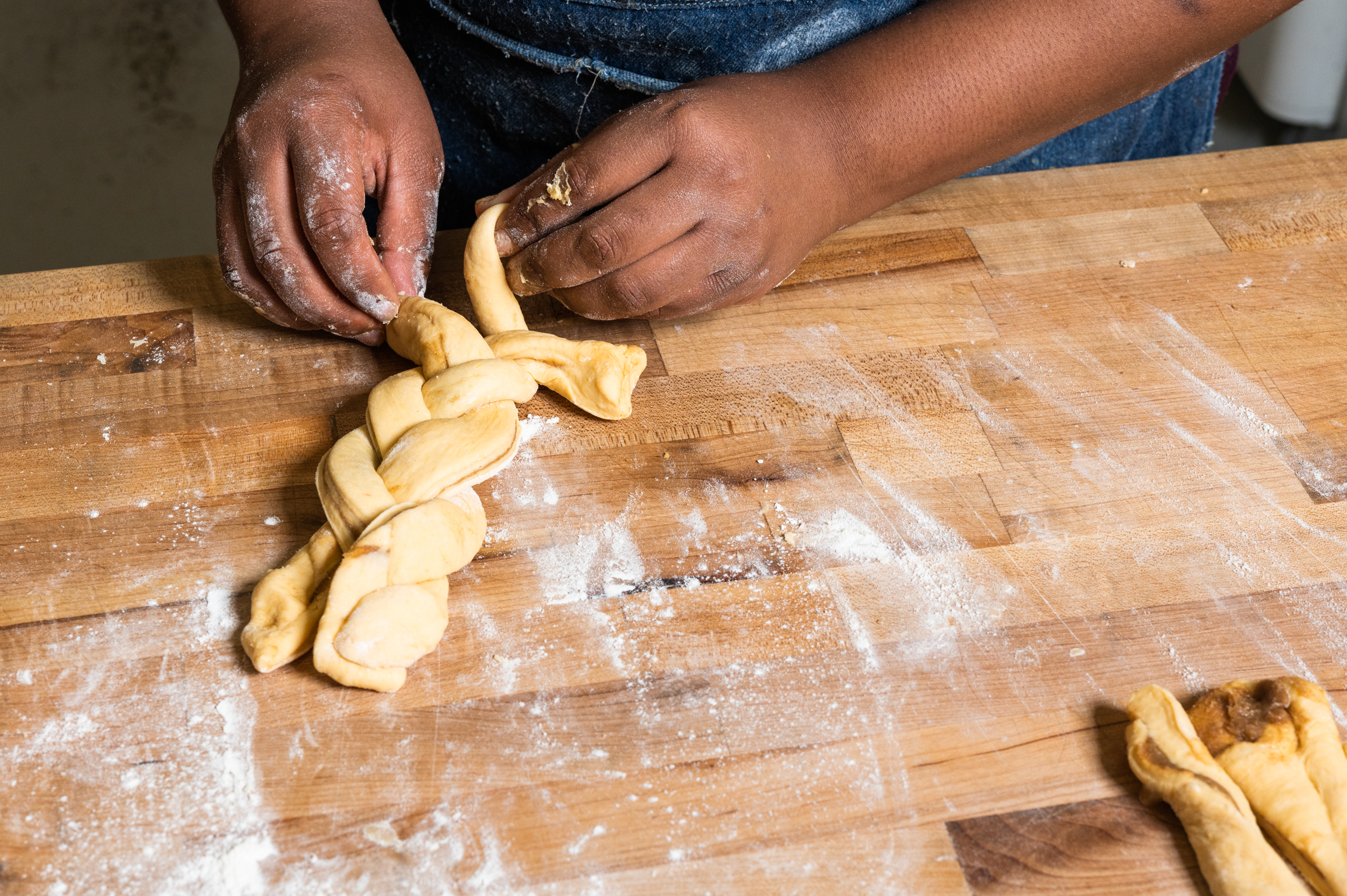 The dough is folded with the sugar mix inside, then cut into strips and braided