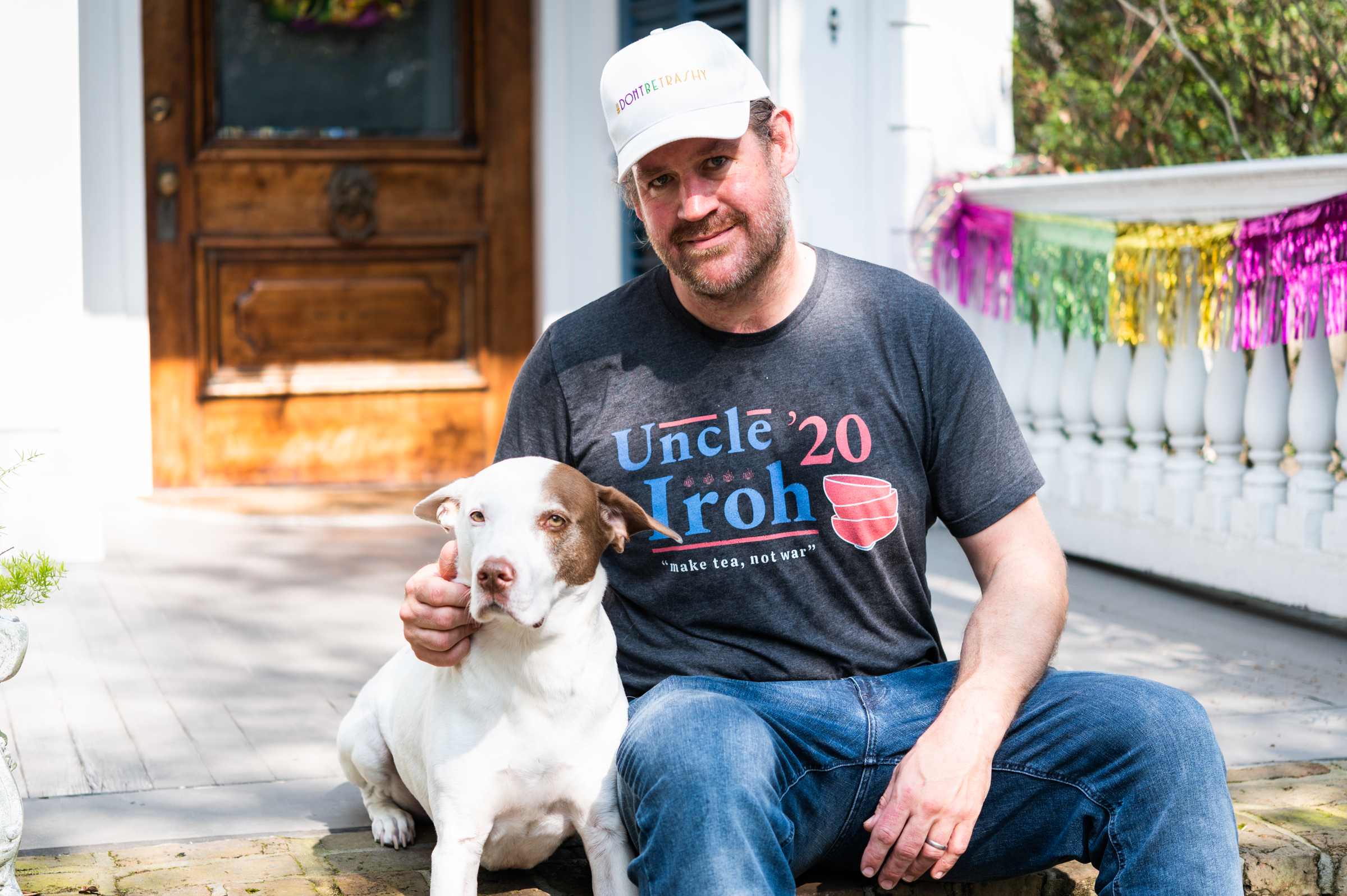Portrait of Jason Goodenough on the porch with his pup
