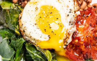 Sautéed collard greens with Creole tomatoes, black-eyed peas and a fried egg