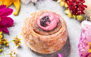 Levee Baking Company's blackberry morning bun surrounded by Pistil & Stamen flowers