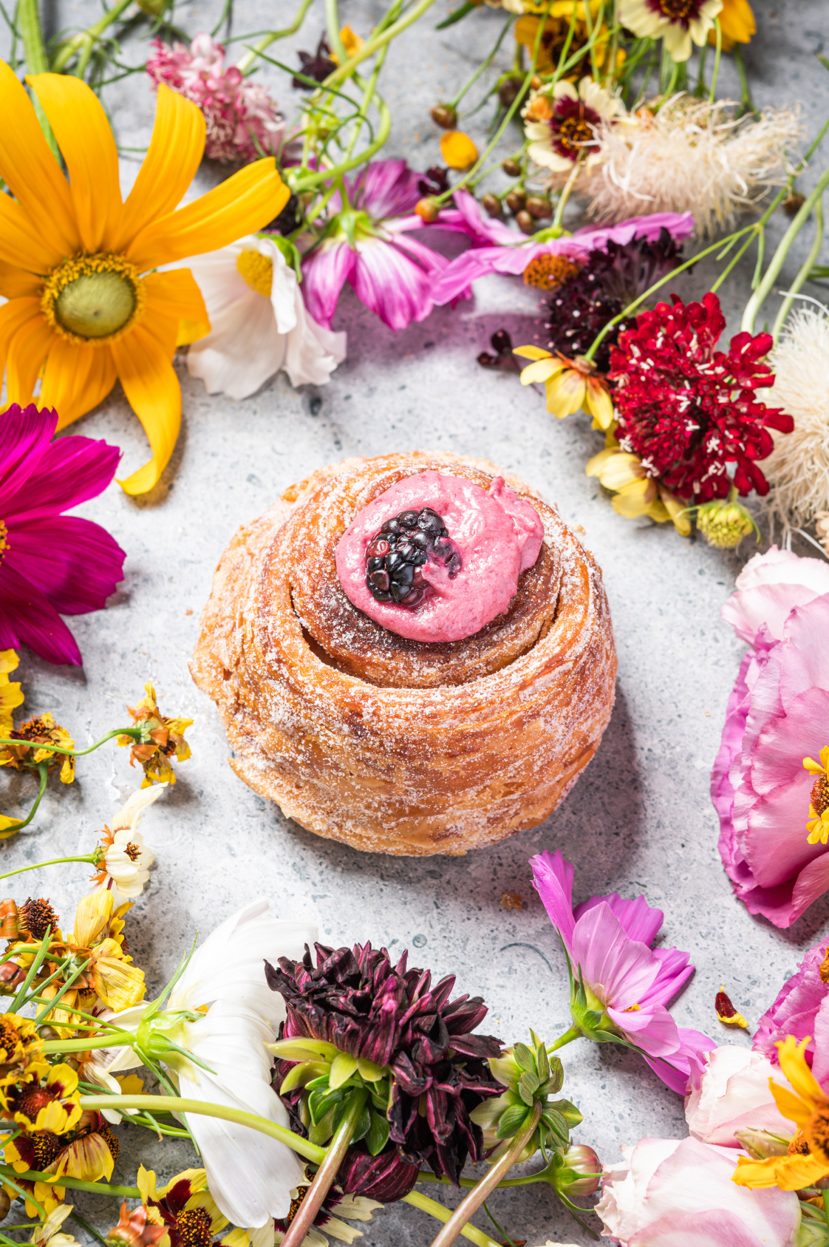 Levee Baking Company's blackberry morning bun surrounded by Pistil & Stamen flowers