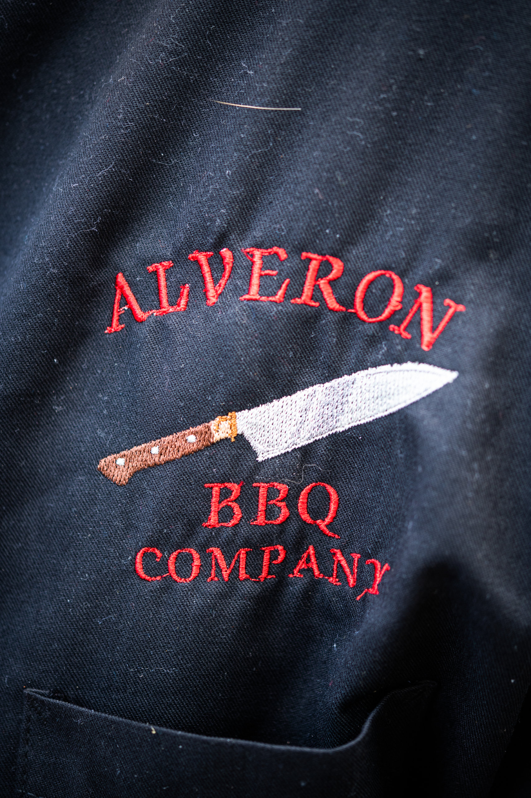 Detail of the Alveron logo on John's chef jacket