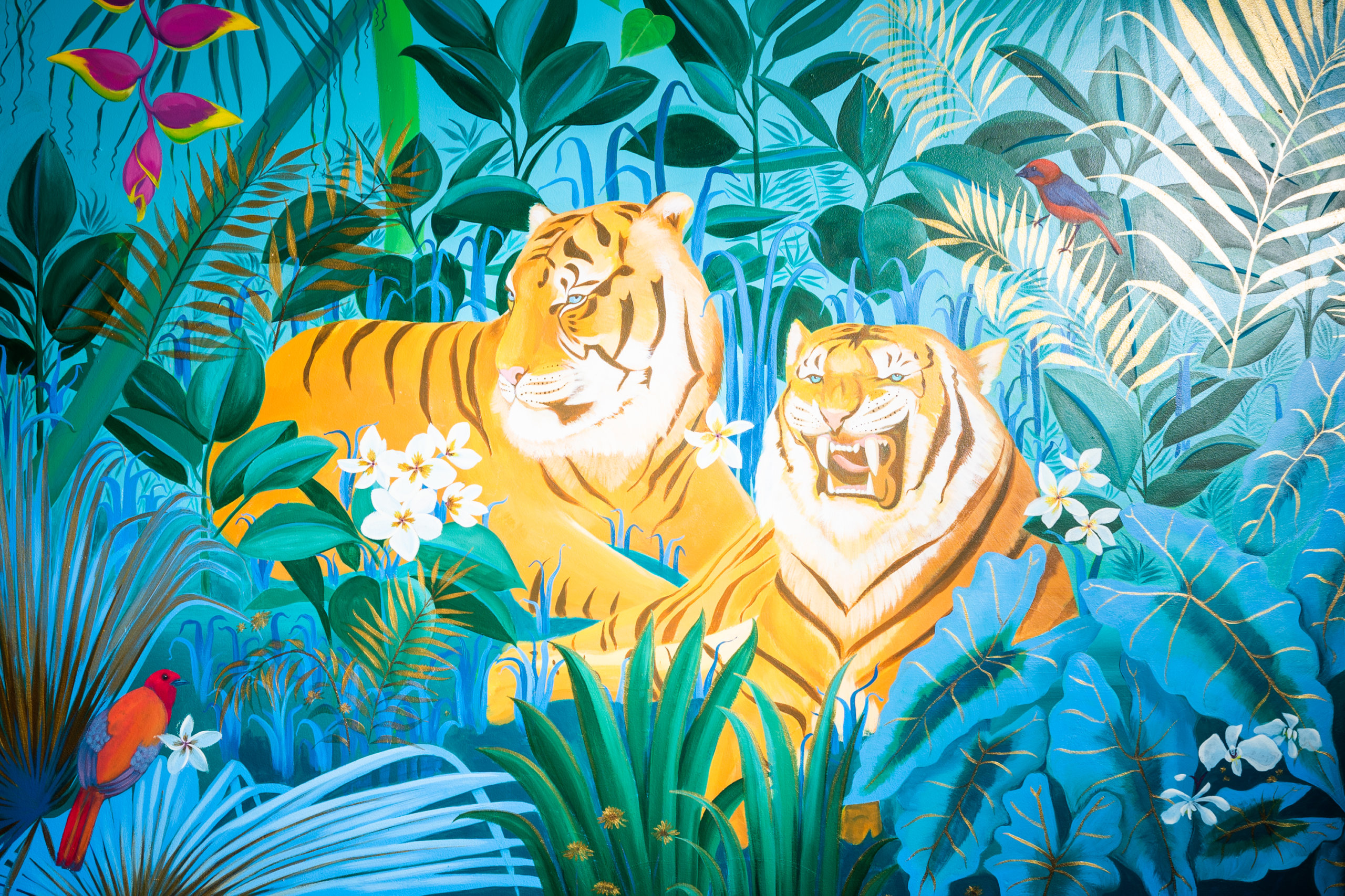 Mural of tigers surrounded by foliage and birds, painted by Margie and the Moon