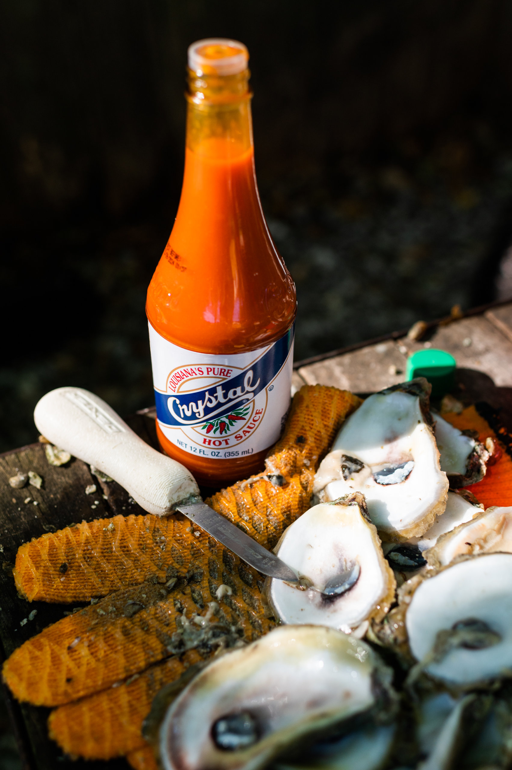 A bottle of Crystal next to freshly-shucked oysters