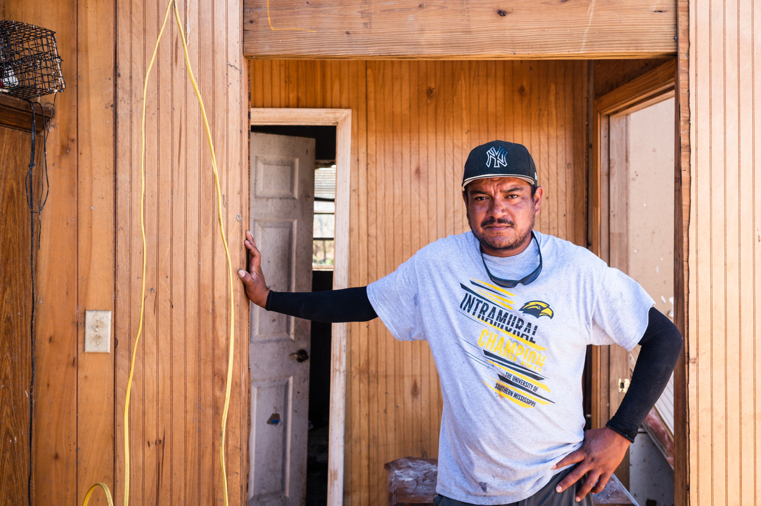 Luis Armendariz stands in the hallway of his home after Hurricane Ida tore his roof off