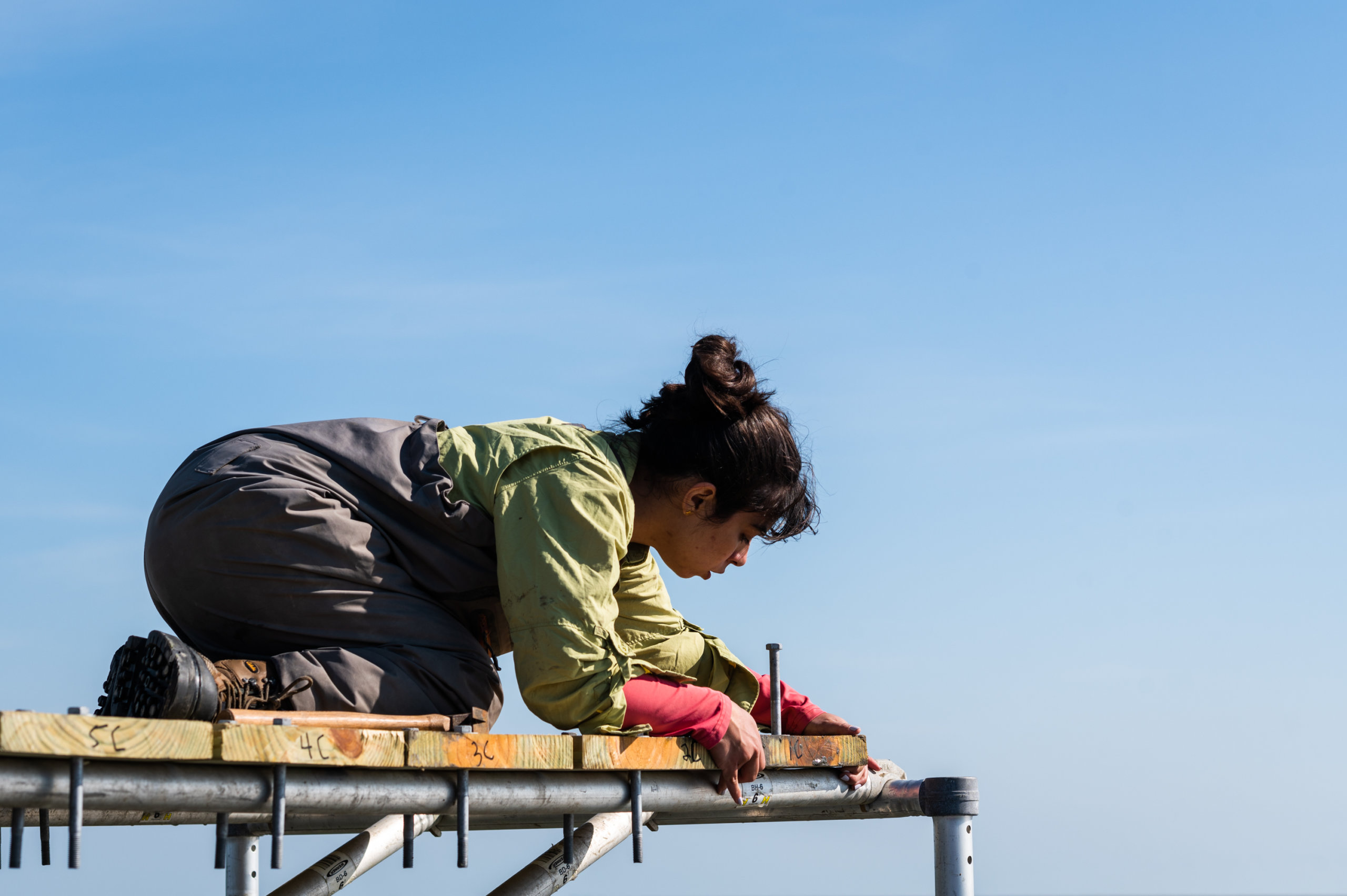 A team member secures the decking atop a research platform